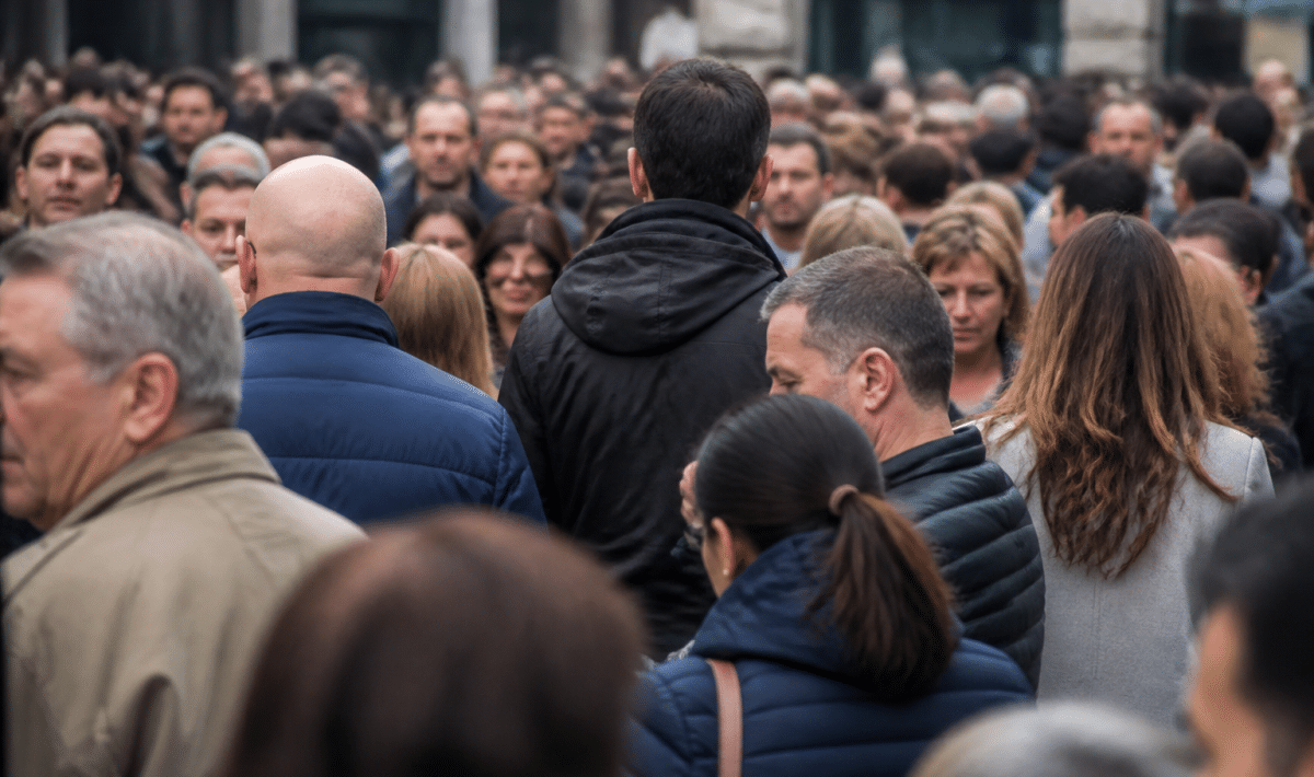 Foule de personnes debout serrees dans rue urbaine